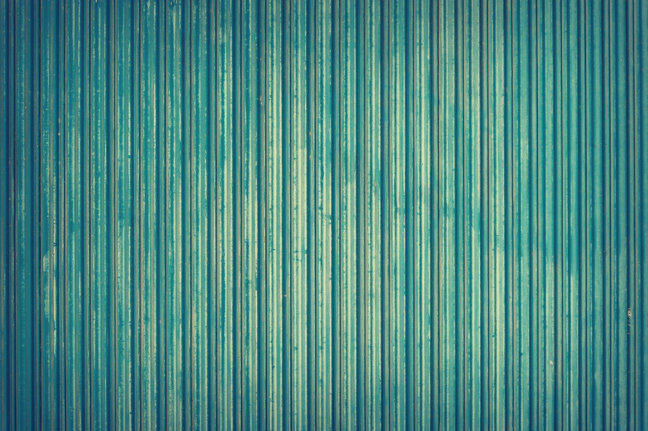 Close-up of TOL Buildings metal roofing panels showing factory-finished surface and substrate