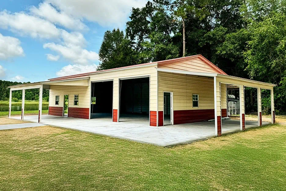 A large TOL metal building with red trim and tan walls — the kind of structure that benefits most from quality insulation